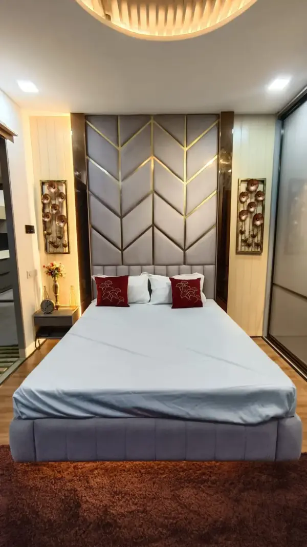 Electronic City home interior – bedroom with upholstered chevron-pattern headboard by Prestige Craft Interiors