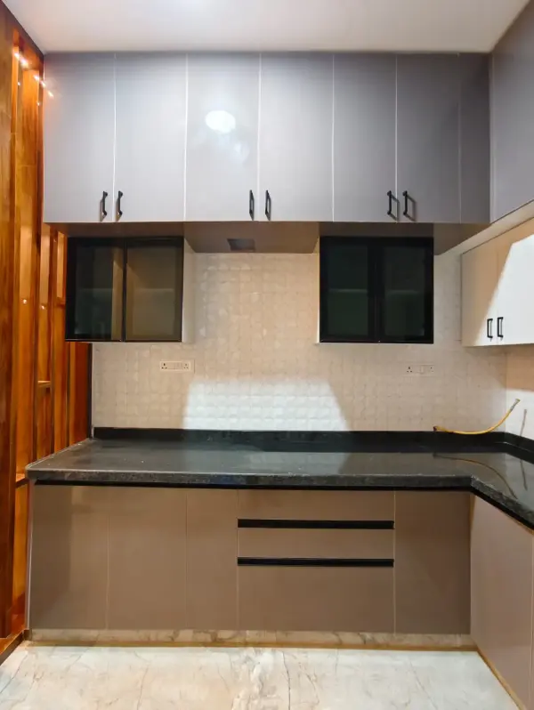 Hebbal home interior – modular kitchen with grey cabinets and glass shutters