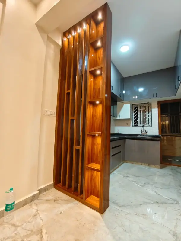 HSR Layout home interior – decorative wooden slat partition leading into the kitchen by Prestige Craft Interiors