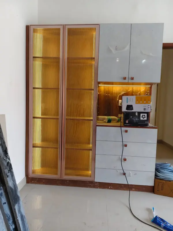 Affordable home interior in Bangalore – wardrobe with fluted glass shutters and LED backlighting by Prestige Craft Interiors