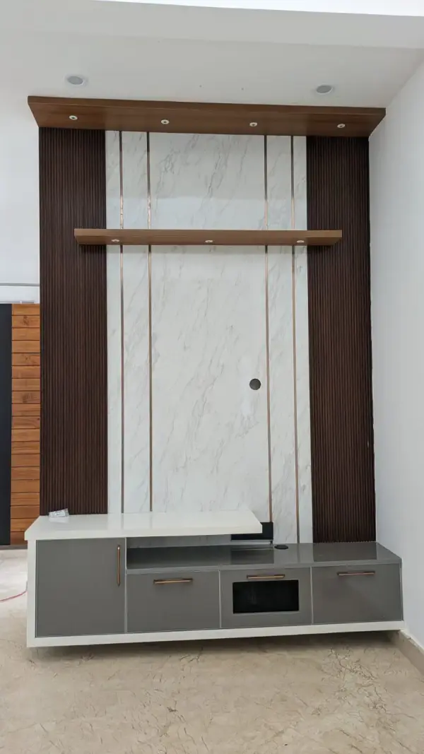 Whitefield home interior – living room TV unit with fluted wood panelling and marble backdrop by Prestige Craft Interiors